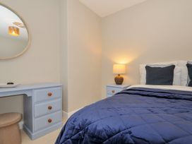 A bedroom with a bed and dresser at 4 Polgrain Turning St. Wenn near St Columb Major