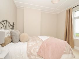 A bedroom with a bed and pillows at 4 Polgrain Turning St. Wenn near St Columb Major