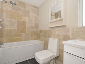 A bathroom with a bathtub, toilet, and sink at 4 Polgrain Turning St. Wenn near St Columb Major