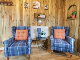 A sitting room with two chairs and a table at The Suffolk in Knutsford