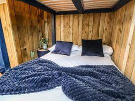 A bed with pillows and blanket at The Suffolk in Knutsford