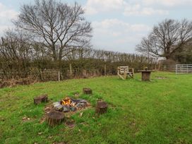 An outdoor area with a fire pit and seating at The Suffolk in Knutsford