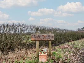 A sign for The Suffolk Hut with flowers at The Suffolk Hut in Knutsford