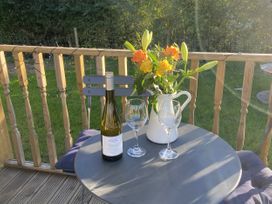 A table with wine and flowers at The Suffolk Hut in Lower Peover, Cheshire