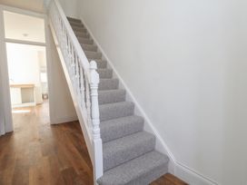A staircase with a handrail in a hallway at 93 Abbotsbury Road Weymouth