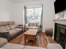 A living room with sofas and a coffee table at 93 Abbotsbury Road in Weymouth