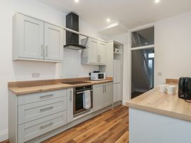 A kitchen with cabinets and appliances at 93 Abbotsbury Road in Weymouth