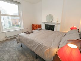 A bedroom with a bed and dresser at 93 Abbotsbury Road in Weymouth