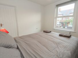 A bedroom with a bed and window at 93 Abbotsbury Road in Weymouth