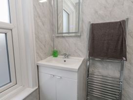 A bathroom with a sink and towel rack at 93 Abbotsbury Road Weymouth