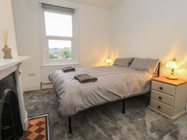 A bedroom with a bed, bedside lamps and a window at 93 Abbotsbury Road Weymouth