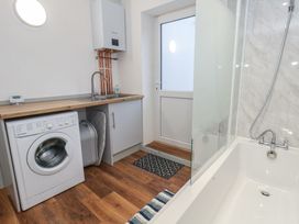 A bathroom with a washing machine and sink at 93 Abbotsbury Road, Weymouth