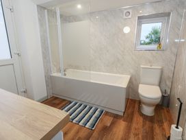 A bathroom with a bathtub and toilet at 93 Abbotsbury Road in Weymouth