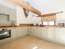 A kitchen with cabinets and appliances at The Forge in Broadway near Stow-On-The-Wold
