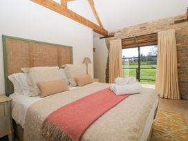 A bedroom with a bed and window at The Forge in Broadway near Stow-On-The-Wold