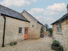 An outdoor area with stone buildings and a gravel path at The Forge in Broadwell near Stow-On-The-Wold