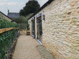 A garden path leading to a door at The Forge in Broadwell near Stow-On-The-Wold