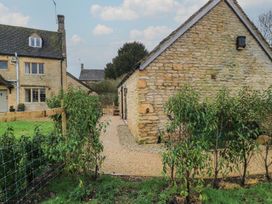An outdoor area with a stone house and pathway at The Forge in Broadwell near Stow-On-The-Wold