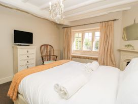 A bedroom with a bed and television at The Smithy in Stow on the wold