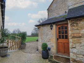 An exterior view of The Smithy with a door and sign in Stow-On-The-Wold