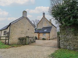 An outdoor view of a stone house and surrounding buildings at The Smithy in Stow-On-The-Wold
