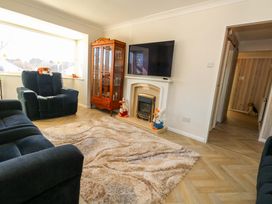 A living room with a television and fireplace at 46 Chafeys Avenue