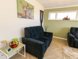 A living room with a sofa and wall art at 46 Chafeys Avenue