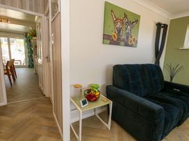 A living room with a sofa, table and painting at 46 Chafeys Avenue