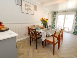 A dining room with a table set for meals at 46 Chafeys Avenue 
