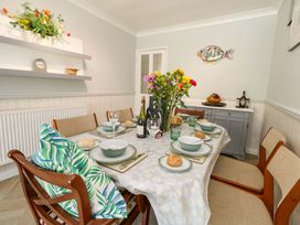A dining room with a table set for dinner at 46 Chafeys Avenue