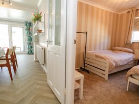 A bedroom with a bed and a chair at 46 Chafeys Avenue