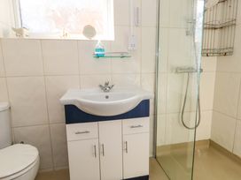 A bathroom with a sink, vanity cabinet, shower and toilet at 46 Chafeys Avenue