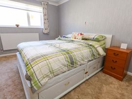 A bedroom with a bed and nightstand at 46 Chafeys Avenue