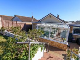 A garden with steps leading to a conservatory at 46 Chafeys Avenue 