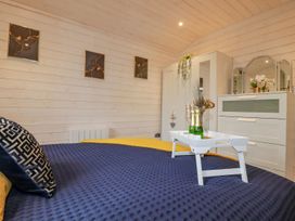 A bedroom with a bed and storage drawers at St. Chad's Lodge in Bodmin