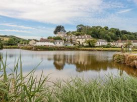 A view of buildings beside a water body at St. Chad's Lodge Luxulyan