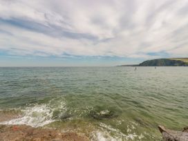 A beach view with water and waves at St. Chad's Lodge in Luxulyan