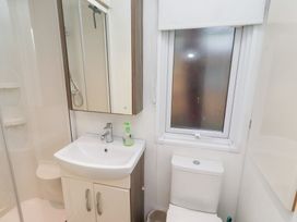 A bathroom with a sink and toilet at Chloe's Cabin Felmoor Holiday Park near Felton
