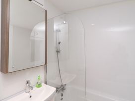A bathroom with a sink and shower at Chloe's Cabin near Felmoor Holiday Park
