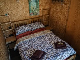 A bedroom with a bed and shelf at The Chard in Carlisle