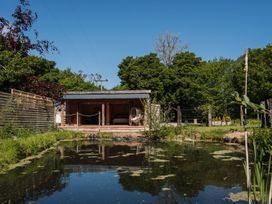 A wooden structure with a pond in front at The Chard in Carlisle