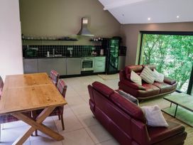 A kitchen and dining area with a table and seating at The Heronry in Carlisle