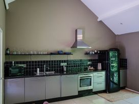 A kitchen with appliances and shelving at The Heronry in Carlisle