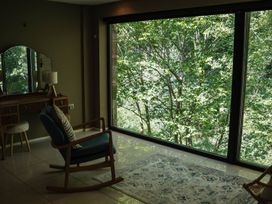 A living room with a chair and dressing table at The Heronry in Carlisle