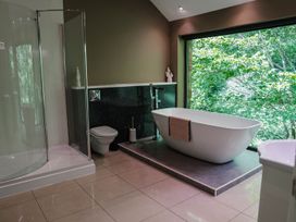 A bathroom with a shower, bathtub, toilet, and sink at The Heronry in Carlisle