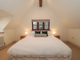 A bedroom with a bed and lamps at Manor Cottage in Carterton, Oxfordshire