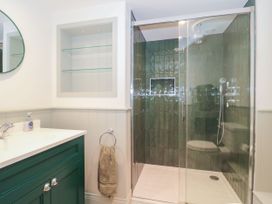A bathroom with a shower and sink at Manor Cottage in Carterton, Oxfordshire