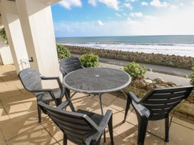 A table and chairs facing the sea at Rock House in Narberth