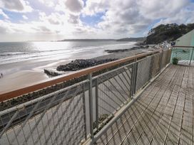 A balcony overlooking the ocean and beach at Rock House in Narberth