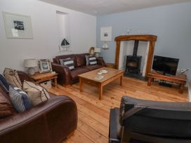 A living room with sofas and a table at Rock House in Narberth